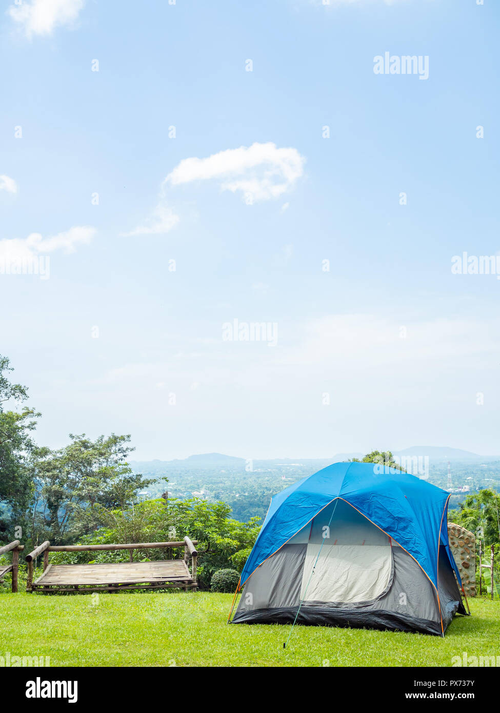 Camping blue tent on green grass with the mountain and blue sky view ...