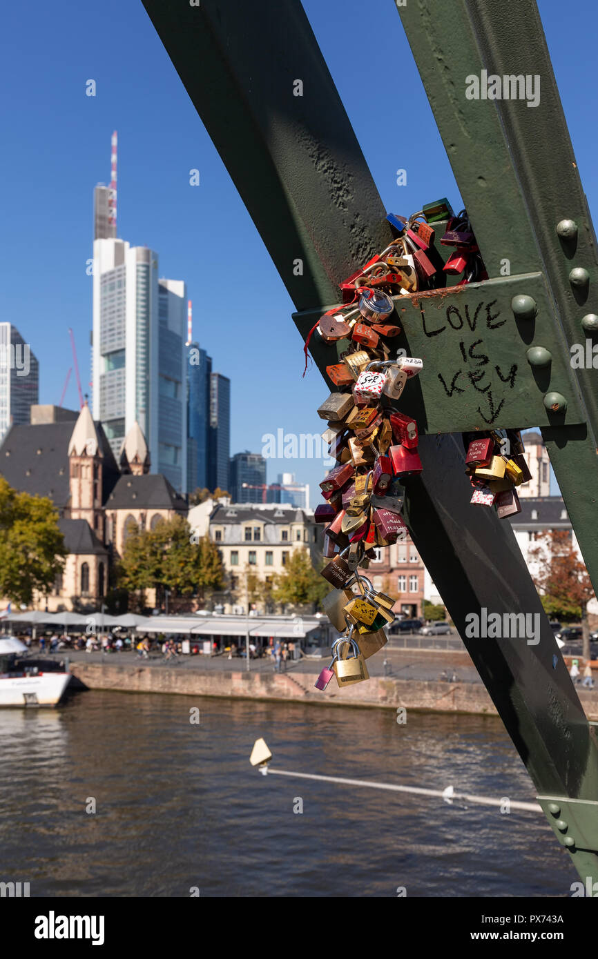 Frankfurt, Germany, October 14th. 2018 - Pedestrian bridge over the river Main with love locks and skyline out of focus in the background. Stock Photo