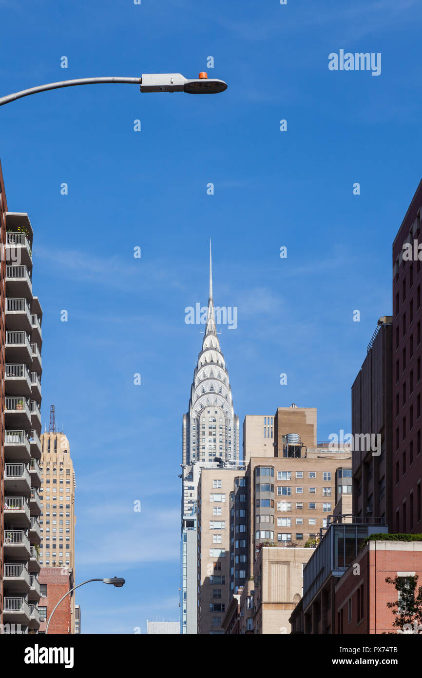 The Chrysler Building overshadows other buildings in Midtown Manhattan.  It was the worlds tallest structure at the time of construction. Stock Photo
