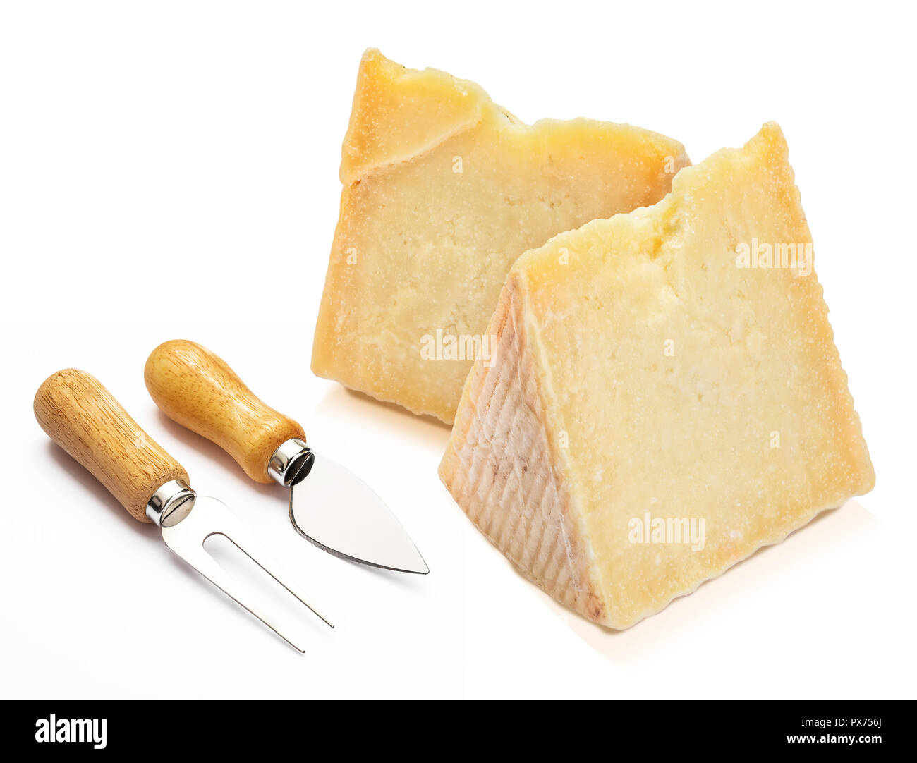 Cured sheep cheese (Manchego type) in wedge and cutlery. Isolated on