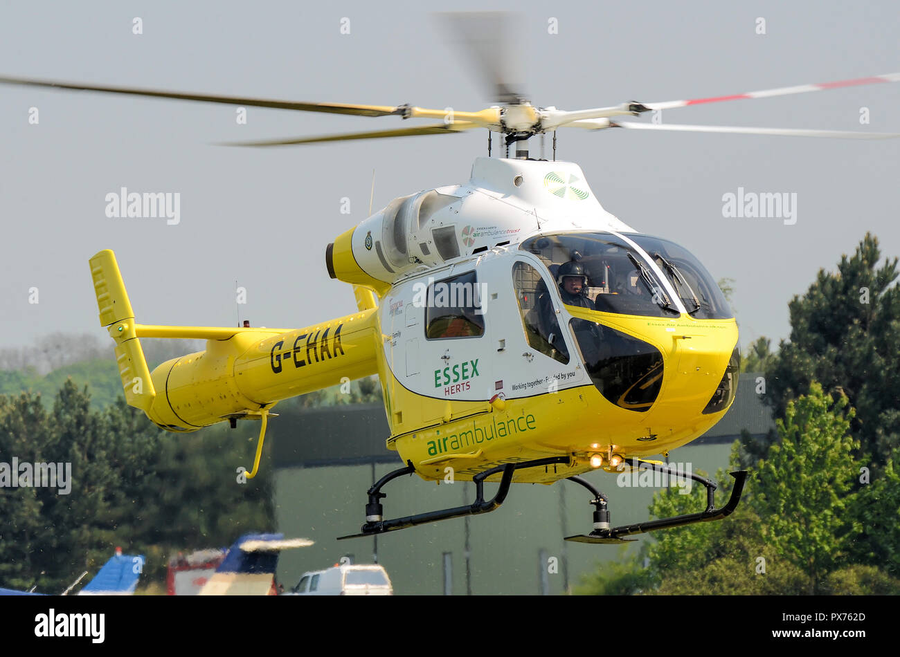 Essex and Herts Air Ambulance landing at Earls Colne. G-EHAA. MD900 Explorer helicopter, medical emergency response. Specialist Aviation Services Stock Photo