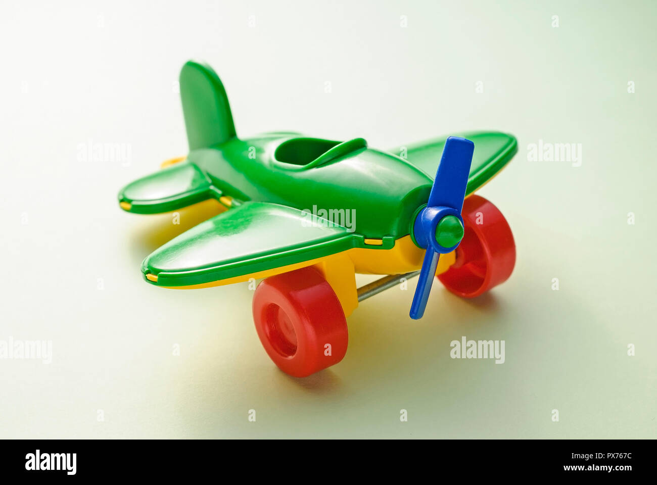 Children's toy green plane on a gradient green background Stock Photo ...