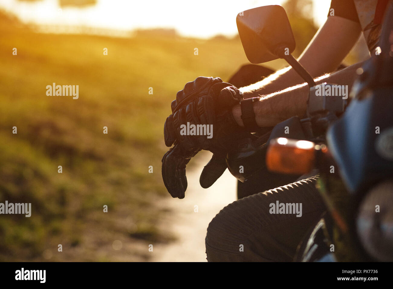 Close-up view on the biker's hands in leather gloves Stock Photo