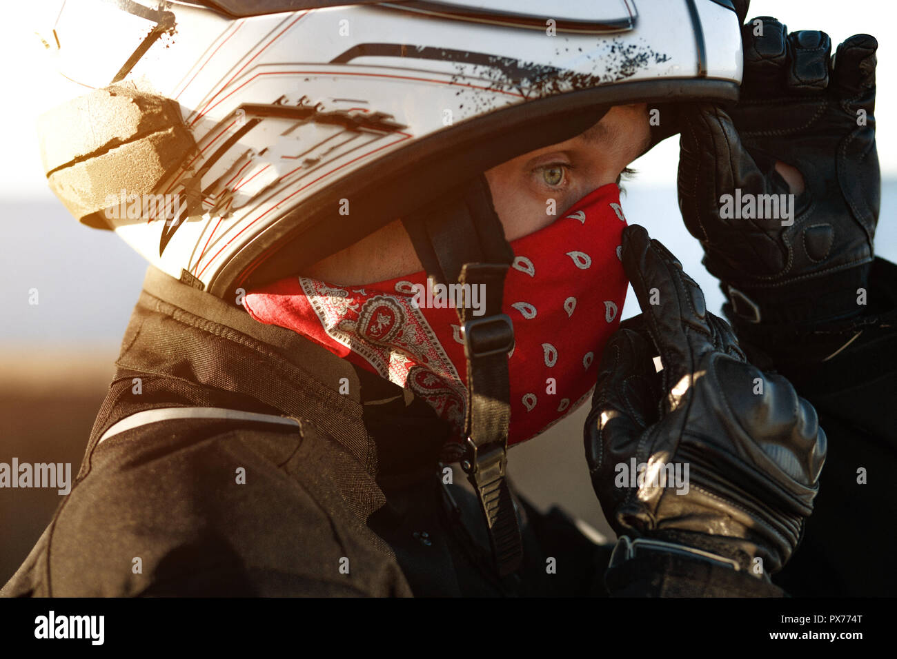 Man in helmet wearing red bandana Stock Photo Alamy