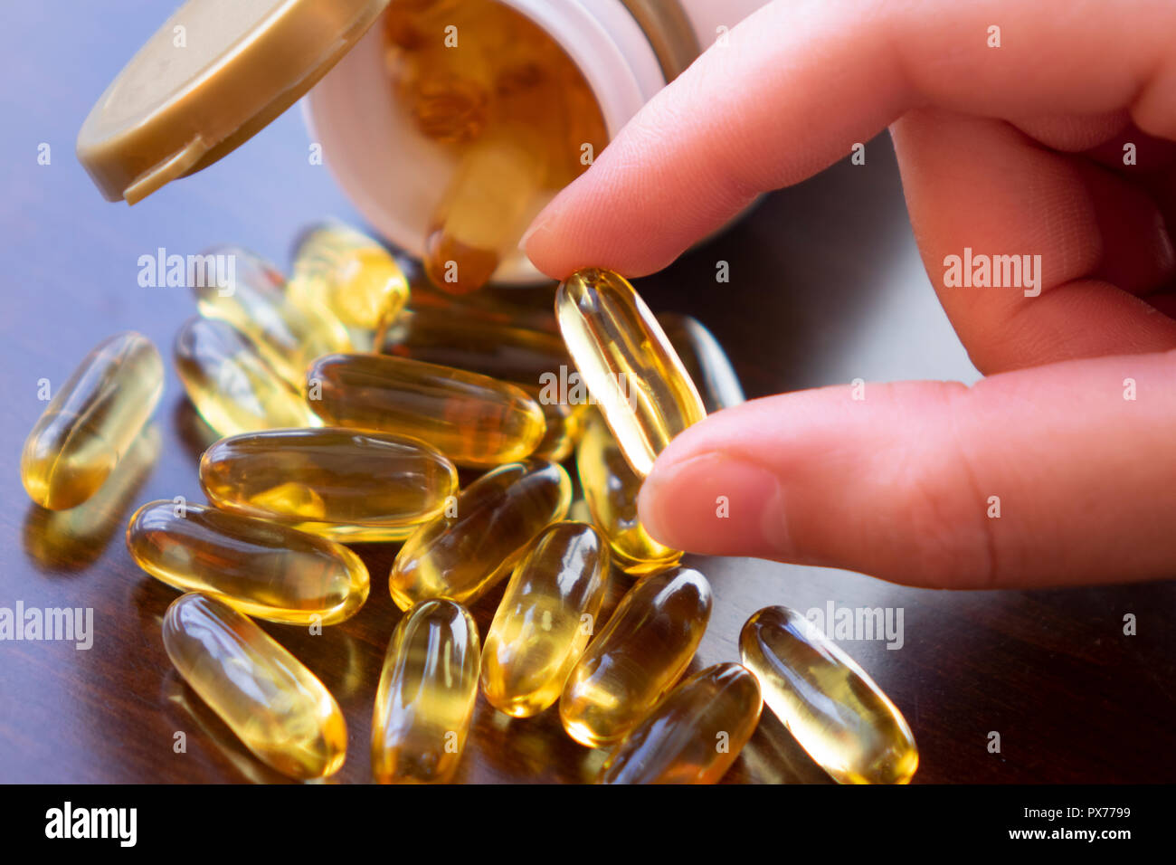 Healthy Diet Nutrition. Woman Holding Fish Oil Pill In Hand. Omega-3. Vitamin And Dietary Supplements. High Resolution Stock Photo