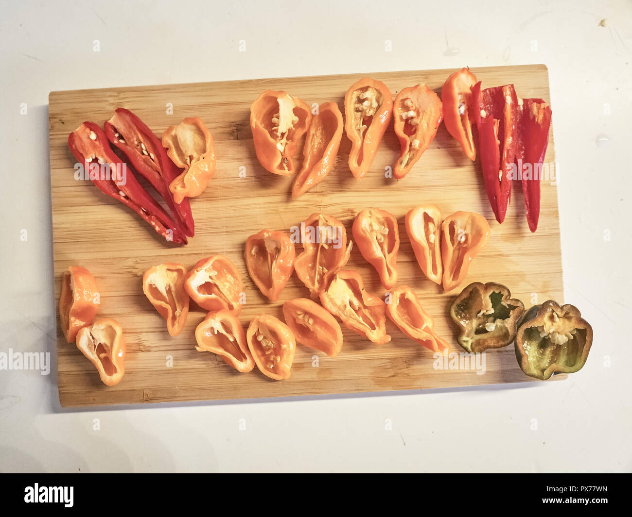 Shot of a mix of Habanero, Naga Morich and Cayenna sliced peppers on a