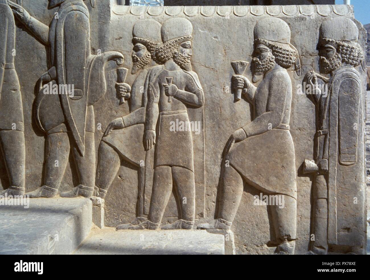 Persepolis. Reliefs on the stairs of the Tripylon, depicting the dignitaries addressing to the party of Nowruz. Detail. Darius I (522-486 BC) and Xerxes I (486-465 BC) period. Islamic Republic of Iran. Stock Photo