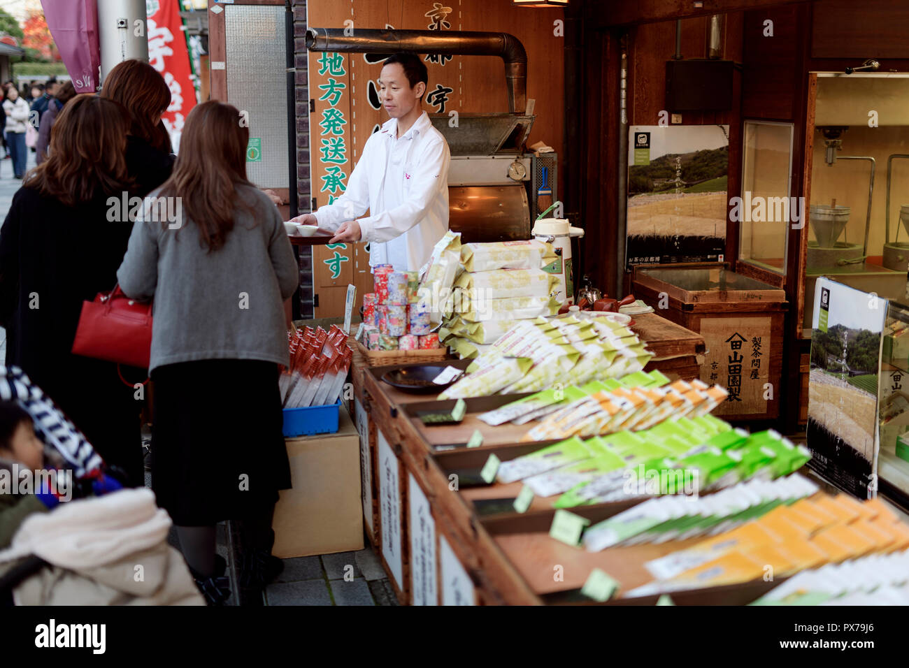 People sampling green tea at a Japanese tea shop in Uji, Kyoto