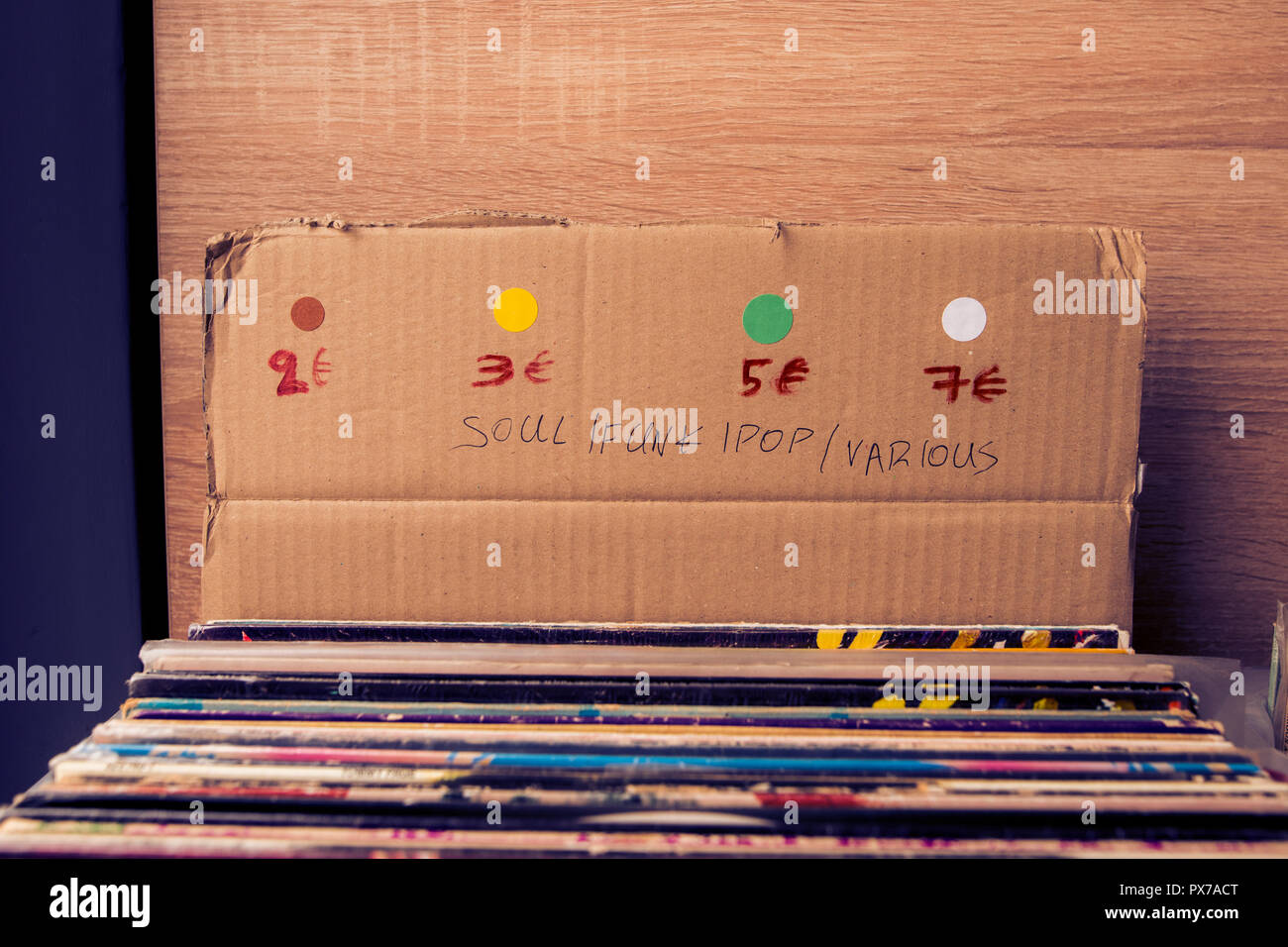 second hand records, in a cardboard box with prices, inside a record
