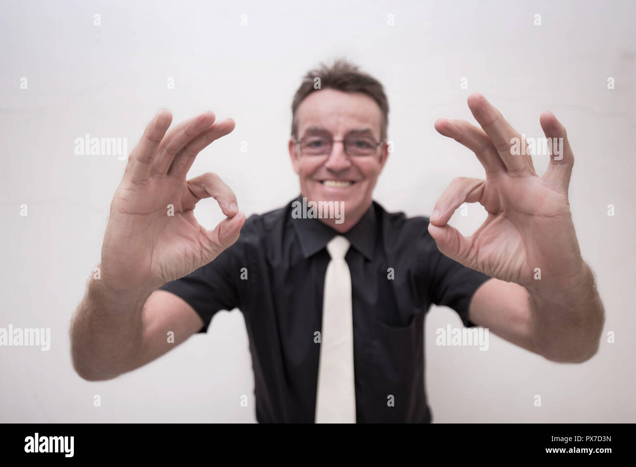 vitality business man 60 years old positive expression confident winner with big smile white teeth black shirt white tie Stock Photo