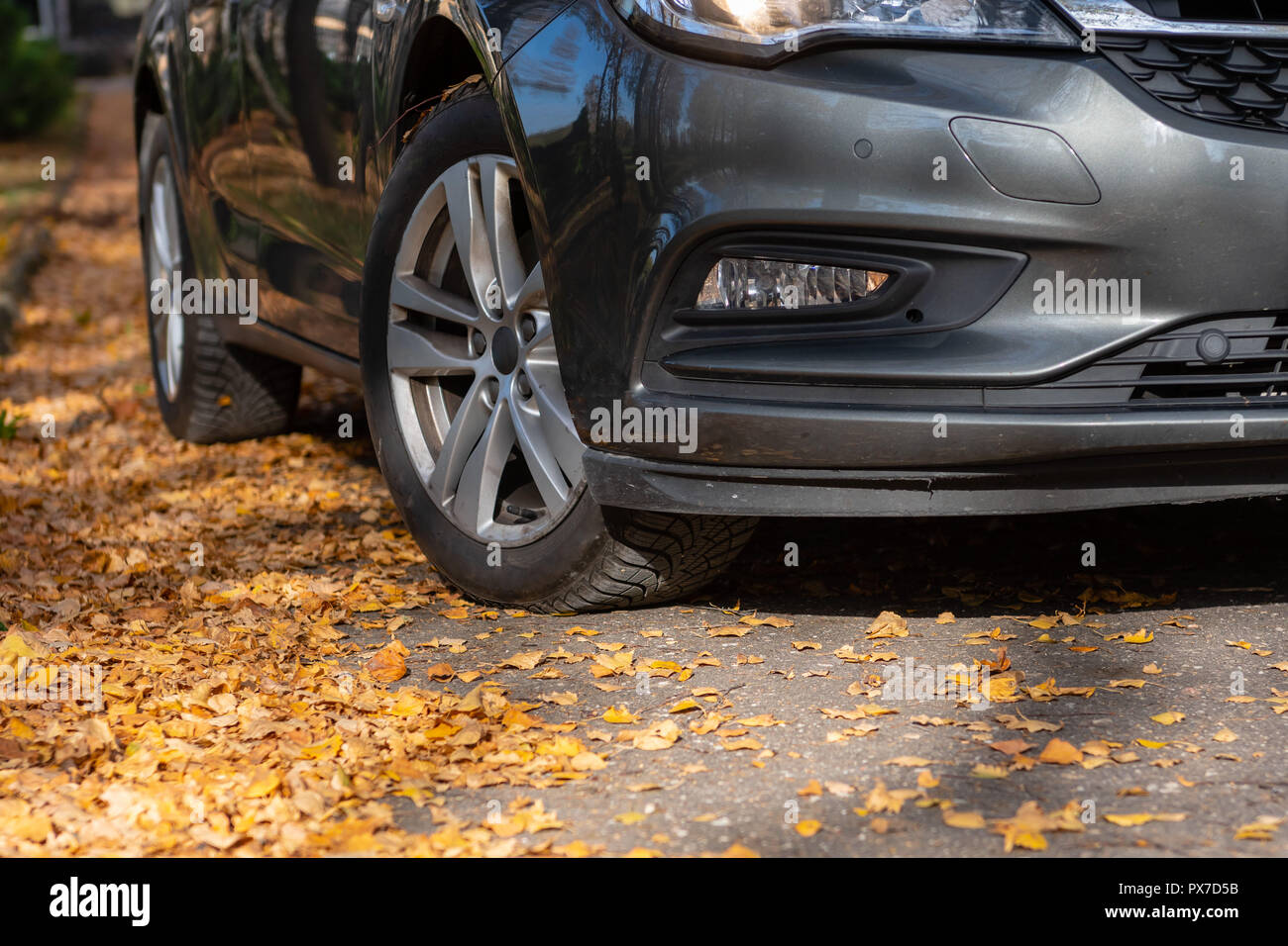 Season tire change. Car with new winter tires on the road for autumn