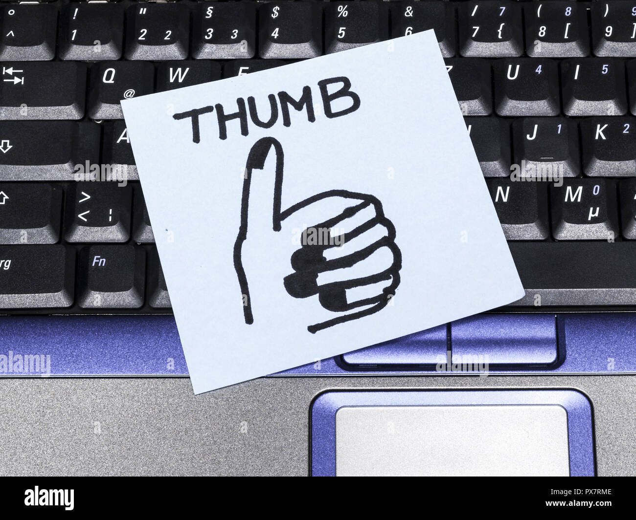 Memo note on notebook, thumb up drawing Stock Photo - Alamy