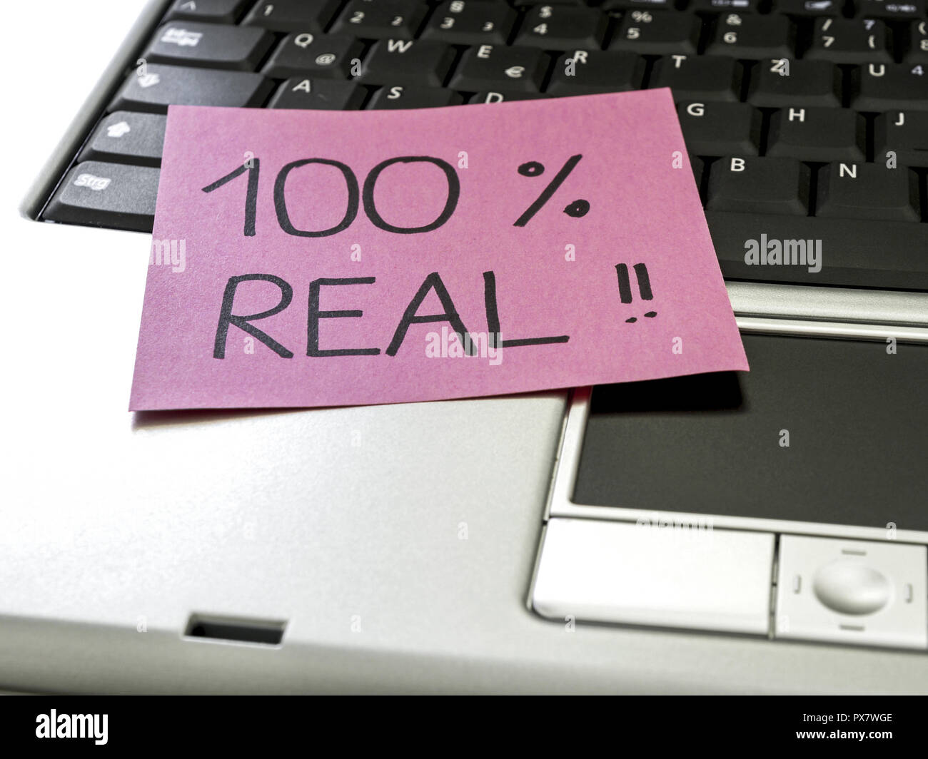 Memo note on notebook, 100 percent real Stock Photo - Alamy