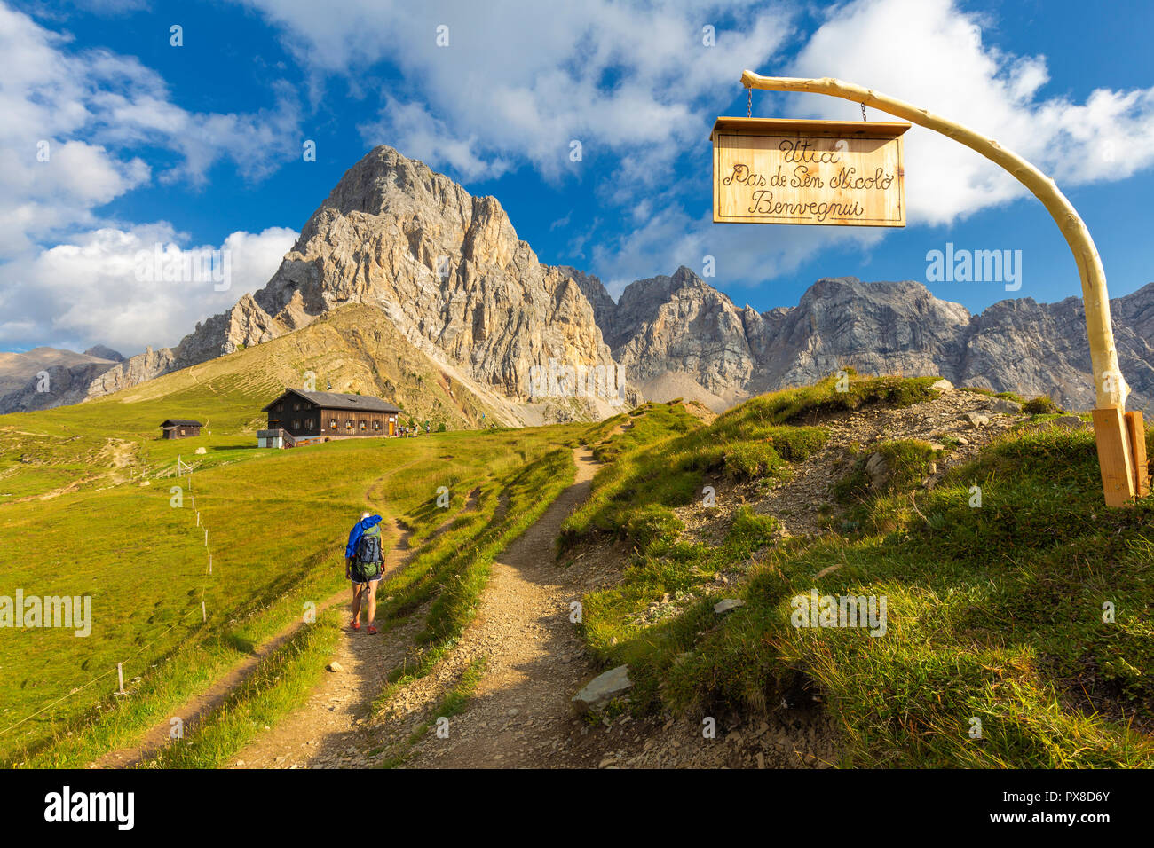 Hiker at Passo San Nicolò Refuge. San Nicolò Pass, Fassa Valley, Trentino, Dolomites, Italy, Europe. Stock Photo