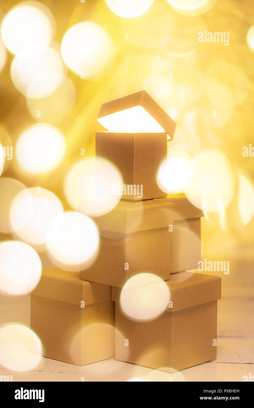 Small cardboard gift boxes with bokeh effect as concept of christmas sale. Stock Photo