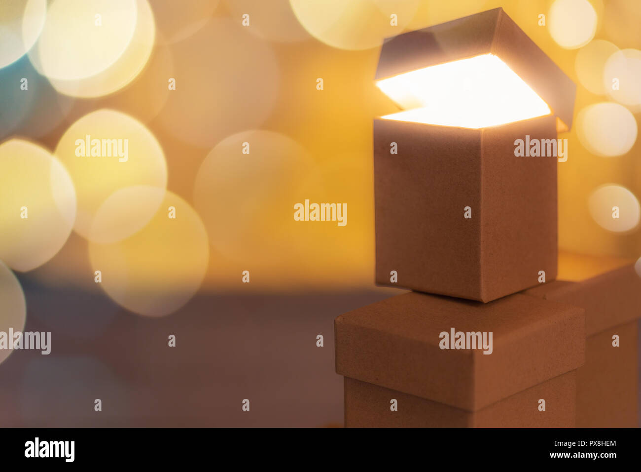 Small cardboard gift boxes with bokeh effect as concept of christmas sale. Stock Photo