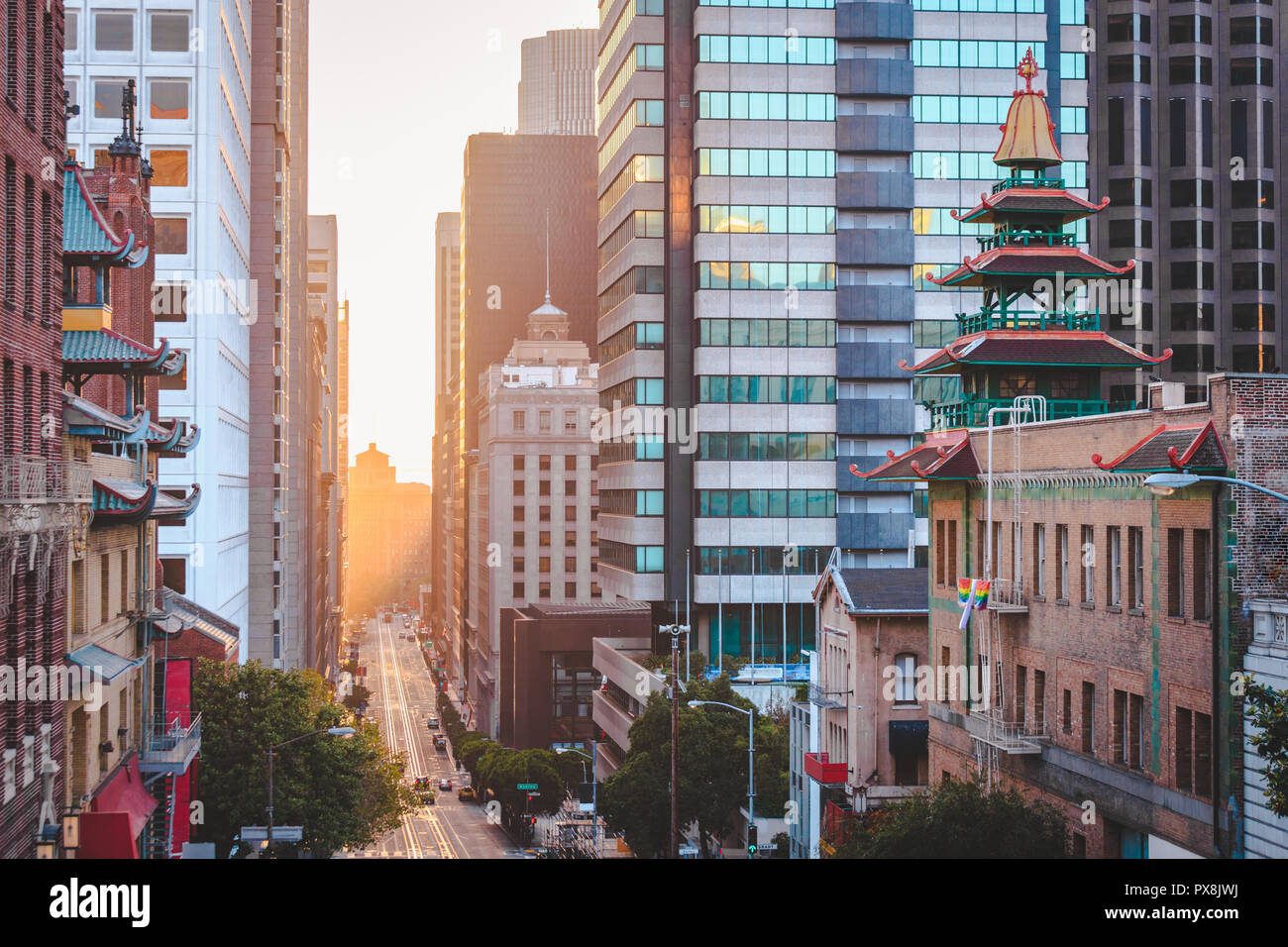 Classic view of downtown San Francisco with famous California Street illuminated in first golden morning light at sunrise in summer, San Francisco Stock Photo