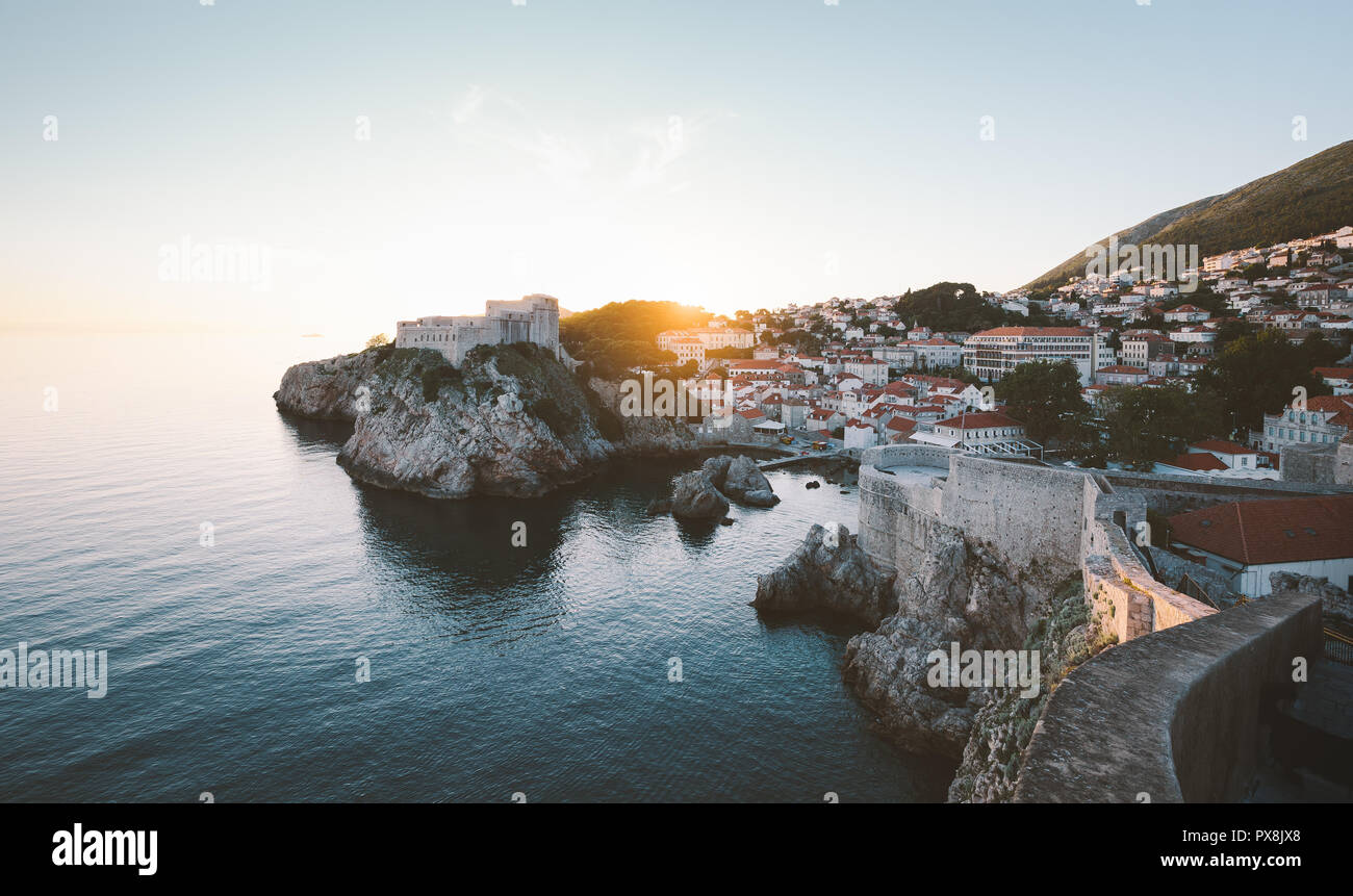 Panoramic view of the old town of Dubrovnik with calm sea in beautiful golden evening light at sunset with blue sky in summer, Dalmatia, Croatia Stock Photo