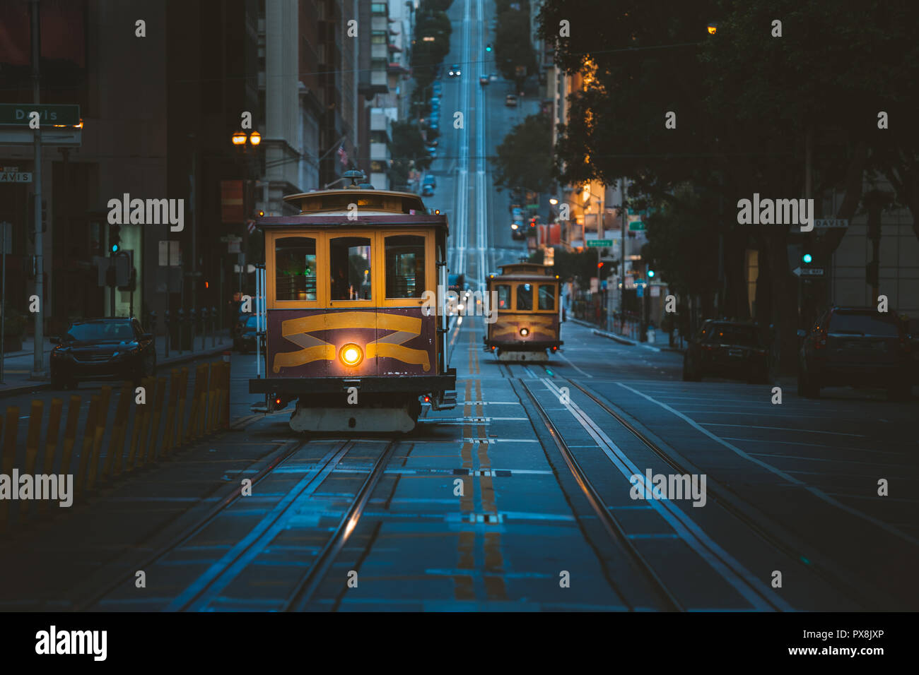 Magical twilight view of historic Cable Cars riding on famous California Street at dawn before sunrise, San Francisco, California, USA Stock Photo