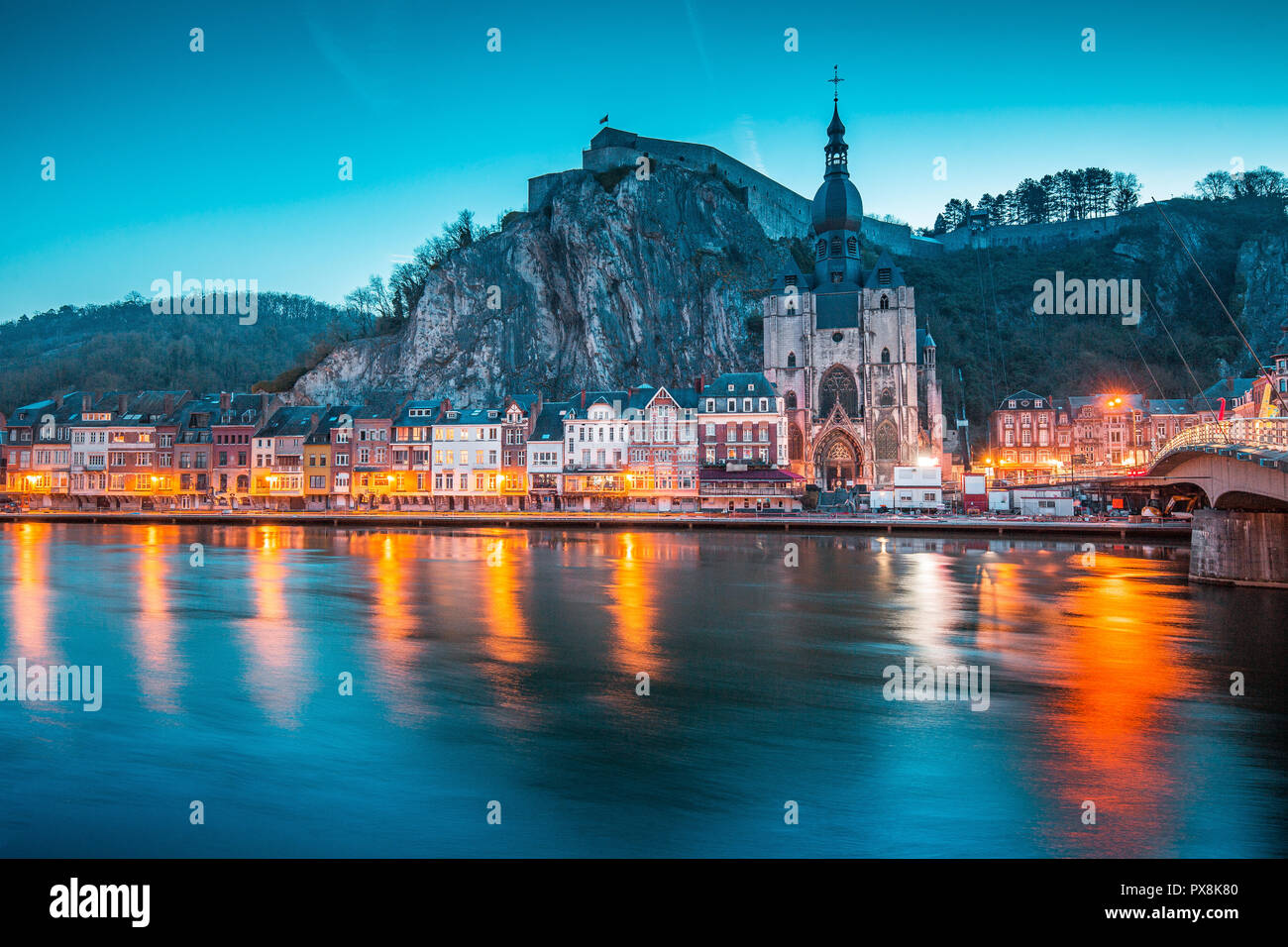 Classic view of the historic town of Dinant with scenic River Meuse in beautiful evening twilight light during blue hour at dusk, province of Namur, W Stock Photo