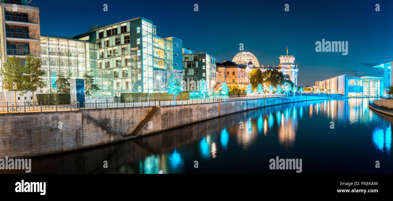 Panoramic twilight view of famous Berlin government district with Spree river during blue hour at dusk, central Berlin Mitte, Germany Stock Photo