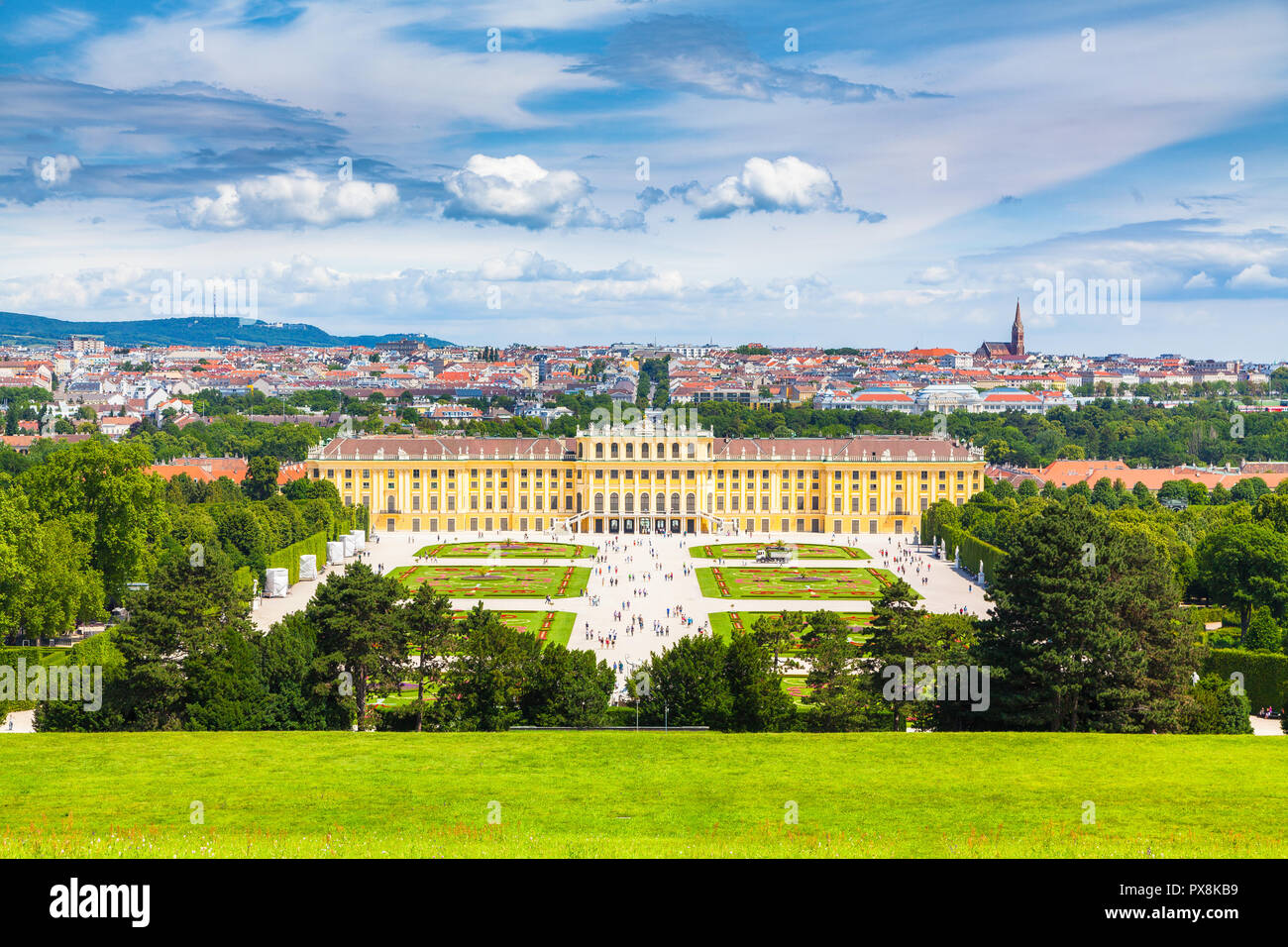 Classic view of famous Schonbrunn Palace with scenic Great Parterre garden on a beautiful sunny day with blue sky and clouds in summer, Vienna Stock Photo