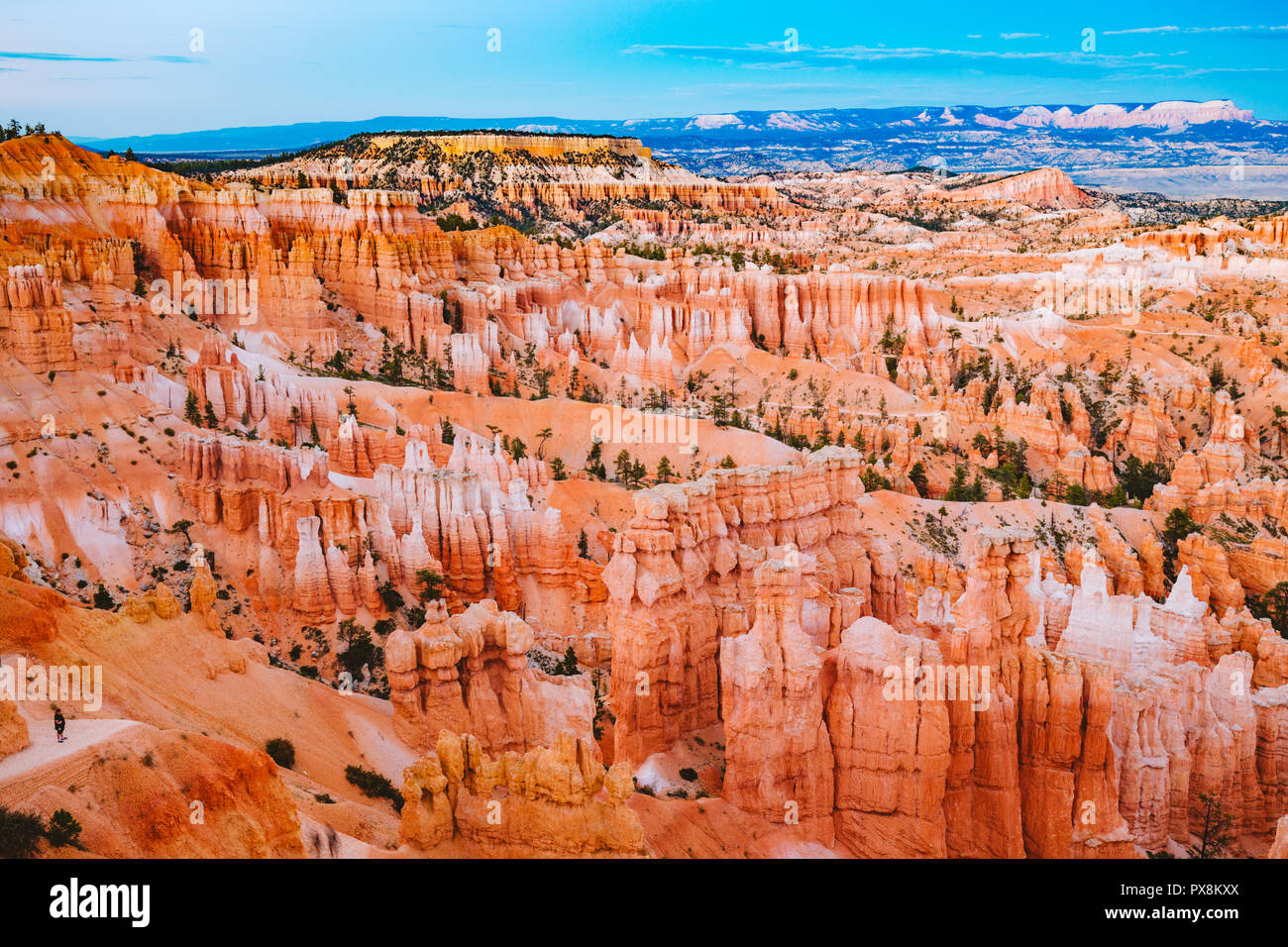 Classic view of Bryce Canyon National Park in beautiful golden evening light at sunset with blue sky and dramatic clouds seen from famous Sunset Point Stock Photo