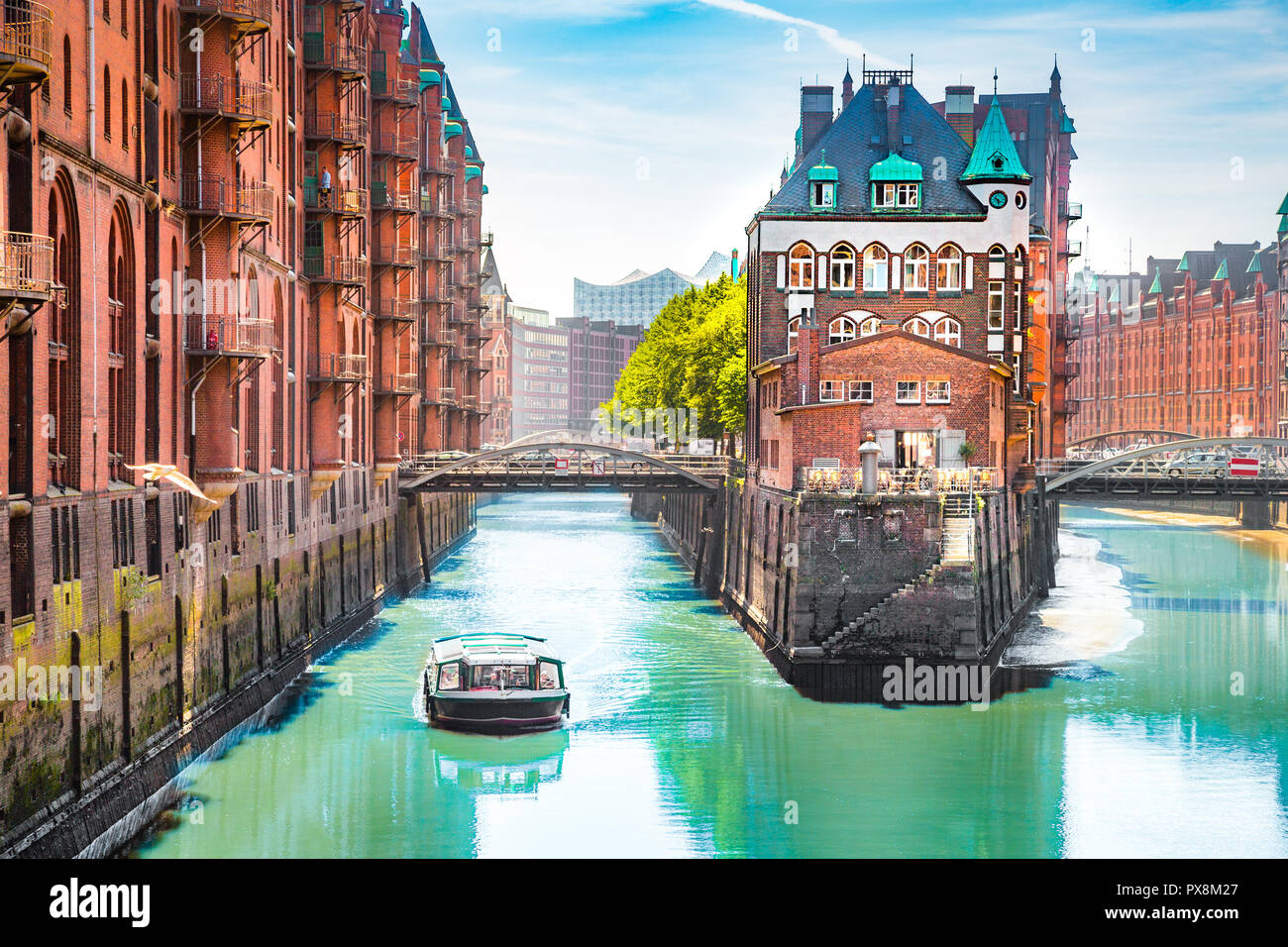 Classic view of famous Hamburg Speicherstadt warehouse district with sightseeing tour boat on a sunny day in summer, Hamburg, Germany Stock Photo