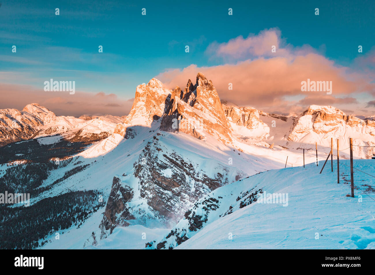 Classic view of famous Seceda mountain peaks in the Dolomites illuminated in beautiful evening light at sunset in winter, South Tyrol, Italy Stock Photo