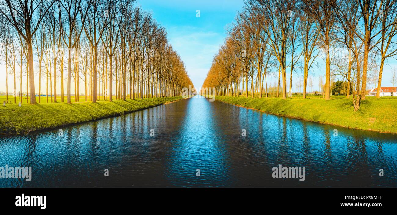 Beautiful view of famous Damme Canal, also known as Damse Vaart or Napoleonvaart, near the city of Brugge in evening light at sunset Stock Photo