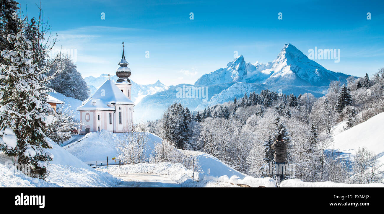 Beautiful winter wonderland mountain scenery in the Alps with pilgrimage church of Maria Gern and famous Watzmann summit in the background, Berchtesga Stock Photo