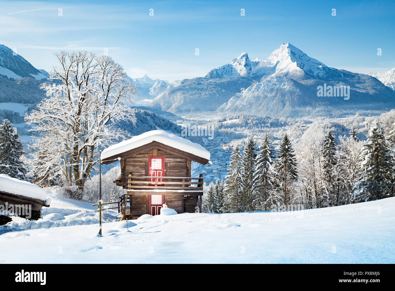 Beautiful view of traditional wooden mountain cabin in scenic winter wonderland mountain scenery in the Alps Stock Photo