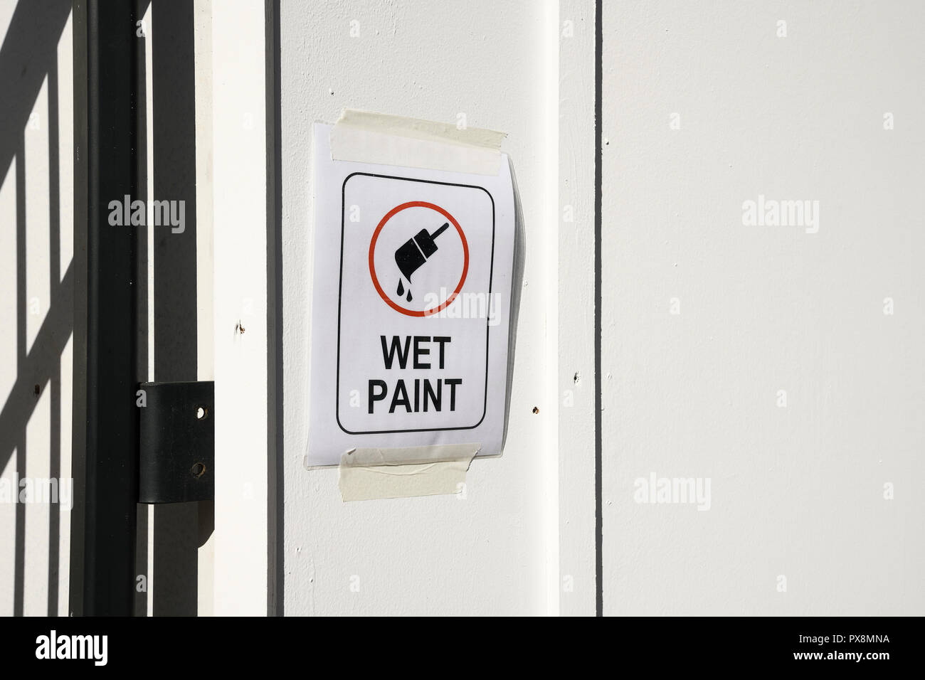 Wet paint sign on wooded hoarding Stock Photo
