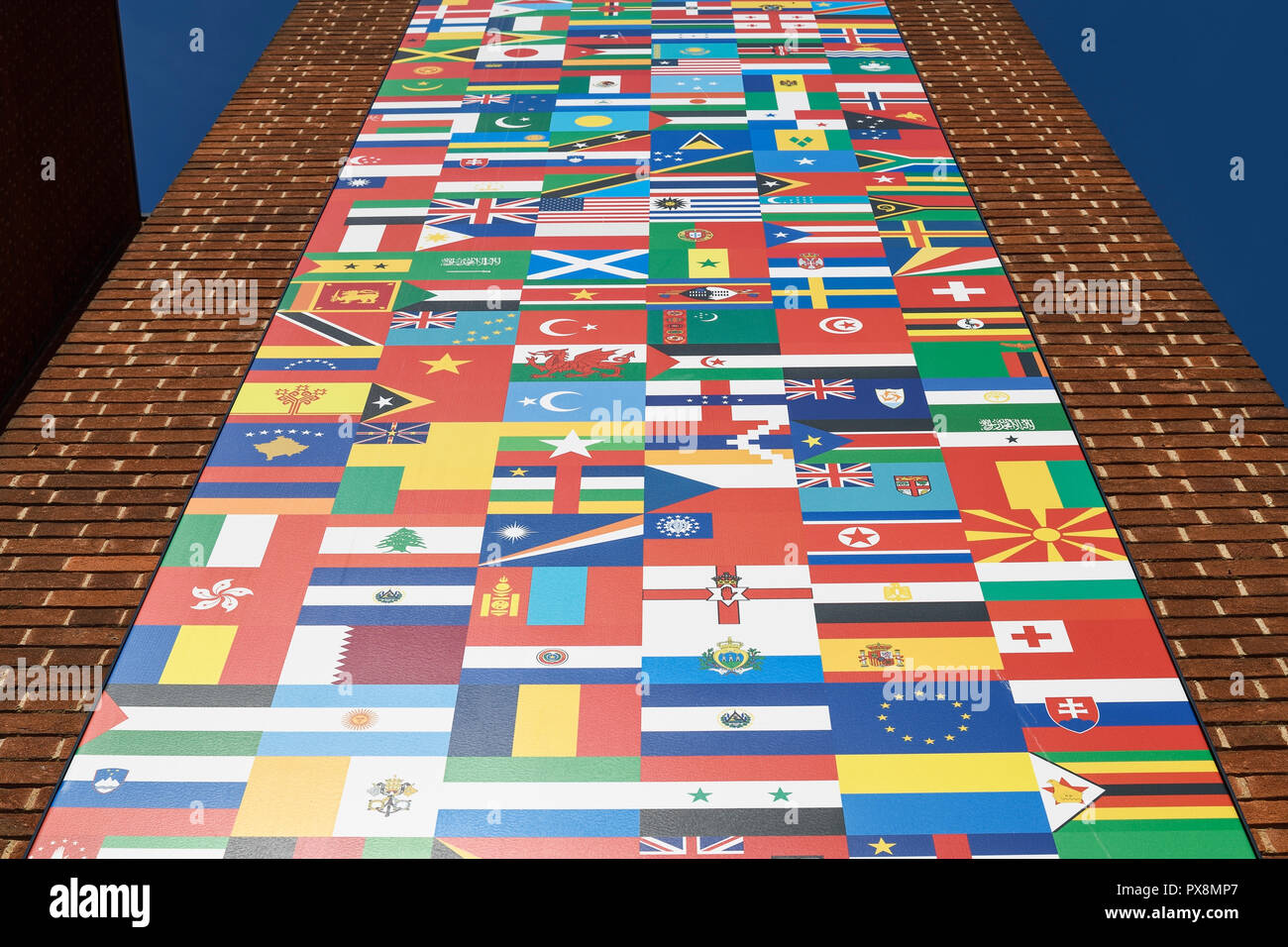 Flags of various nations of the world on the exterior of a building Stock Photo