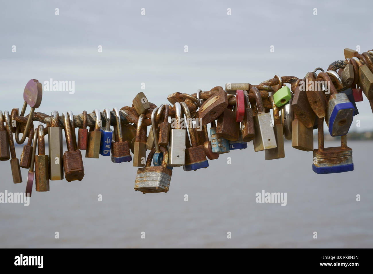 Love locks on a railing overlooking the River Mersey in the Albert Dock