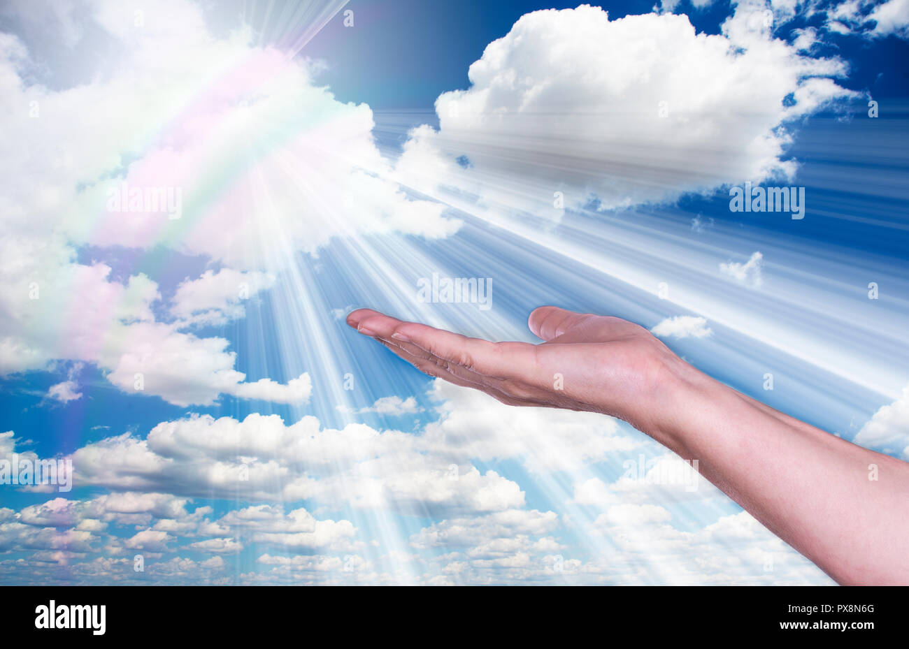 Healing hands in the sky with bright sunburst Stock Photo