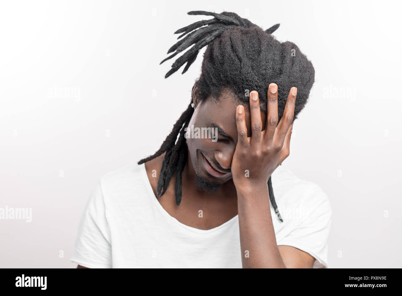 African American man with dreadlocks making facepalm gesture Stock Photo