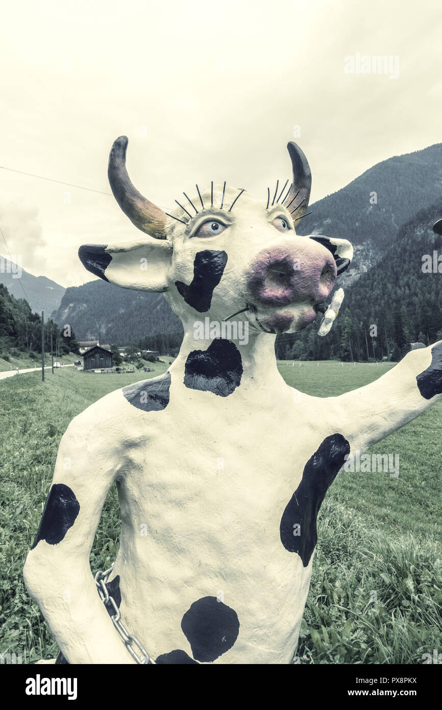 Statue of a female cow in Swiss moutainous landscape, Graubuenden, Switzerland, Grisons Stock Photo