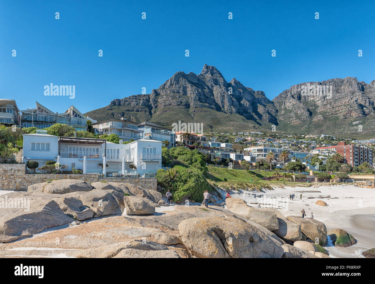 CAPE TOWN, SOUTH AFRICA, AUGUST 9, 2018: Side view of Table Mountain from a beach in Camps Bay. The upper cable station is visible on the highest poin Stock Photo