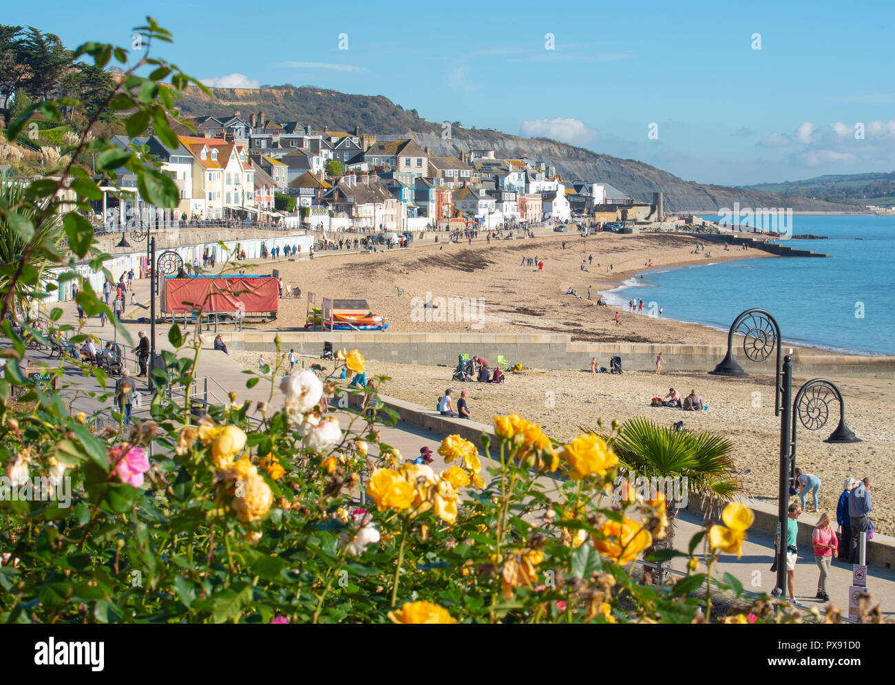 Lyme Regis, Dorset, UK. 20th October 2018.  UK Weather:  Visitors and locals enjoy balmy warm sunshine and clear blue skies at Lyme Regis as the October half term break gets underway. Credit: Celia McMahon/Alamy Live News Stock Photo