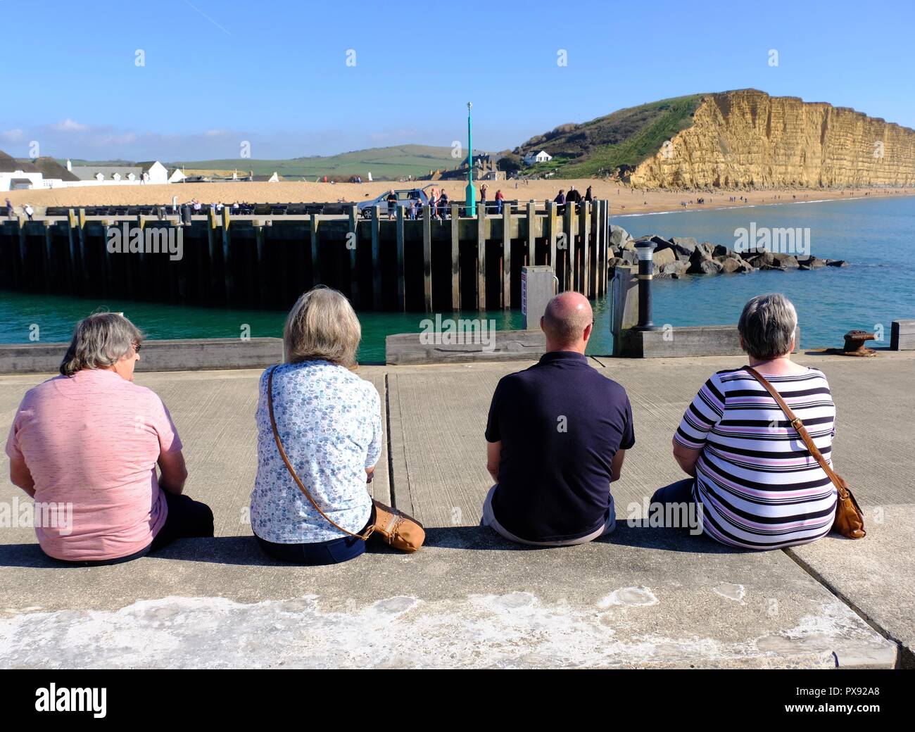 West Bay, Dorset, UK - 20 October 2018 Visitors to West Bay on the Dorset coast enjoy what promises to be the last of the sunshine before the cold weather sets in. Credit: Tom Corban/Alamy Live News Stock Photo