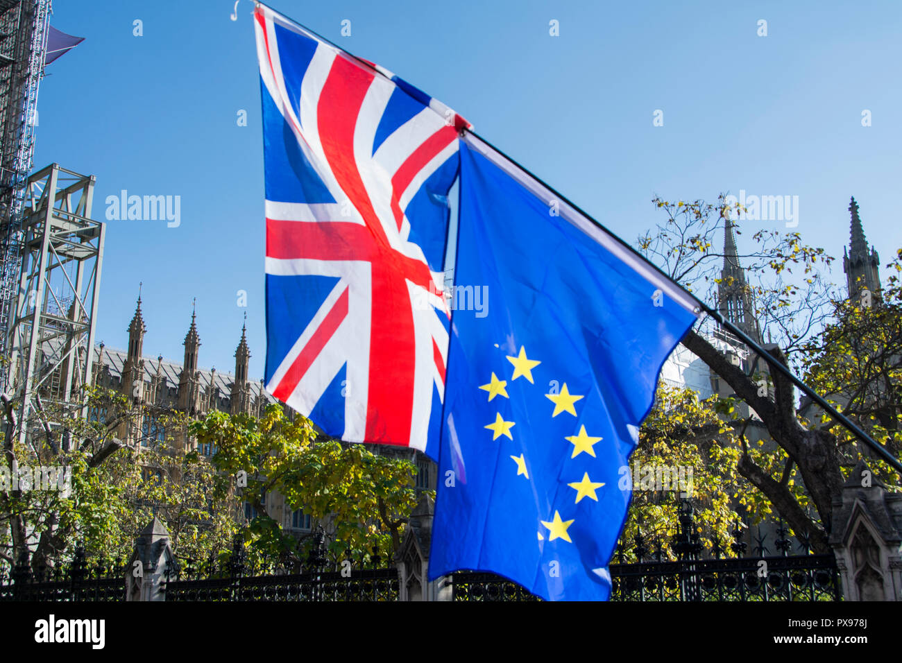 Union Jack and Flag of Europe flags side by side outside Parliament during People's March, London, UK Stock Photo