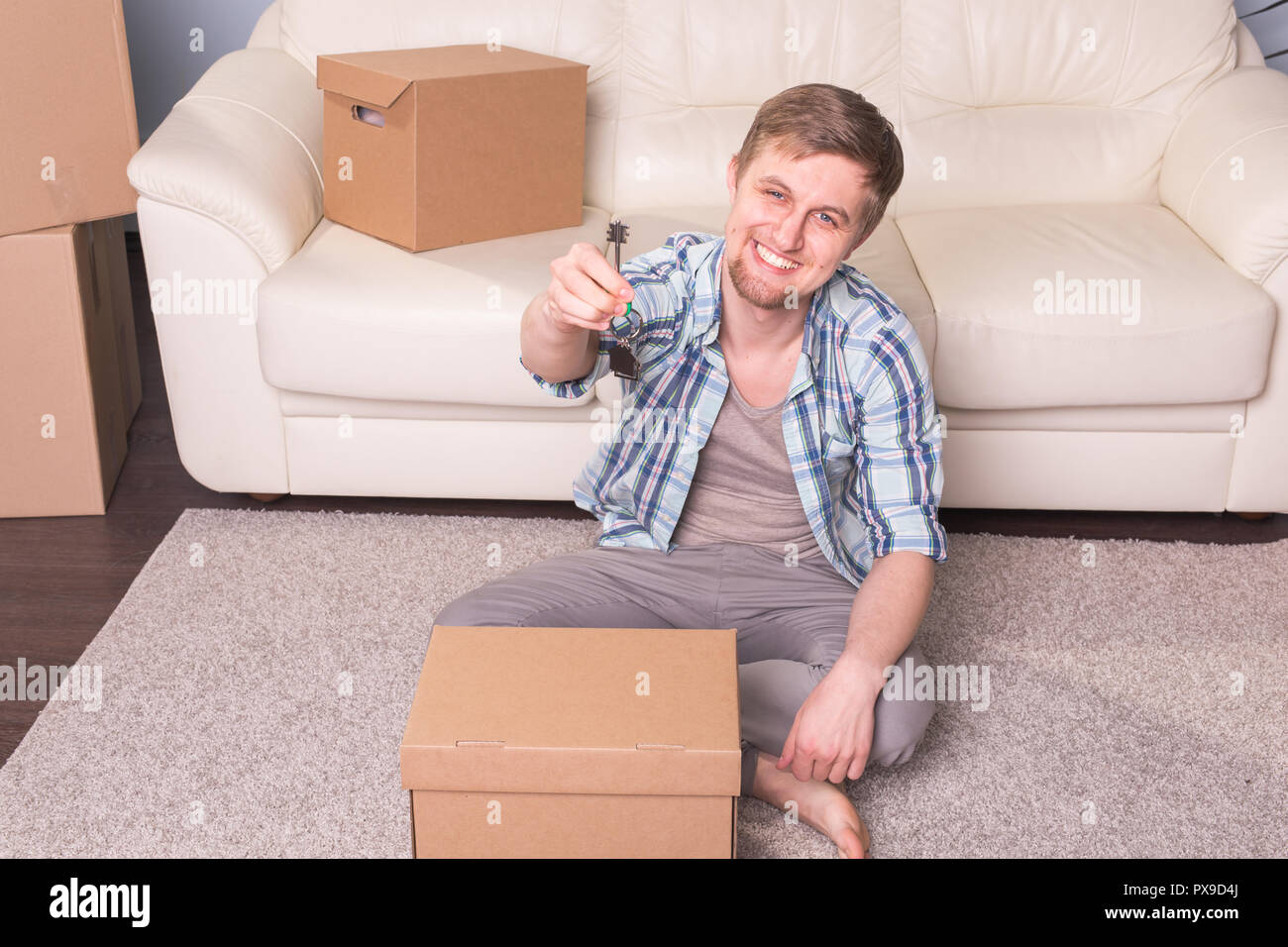 New home, real estate owner and moving concept - happy young man ...