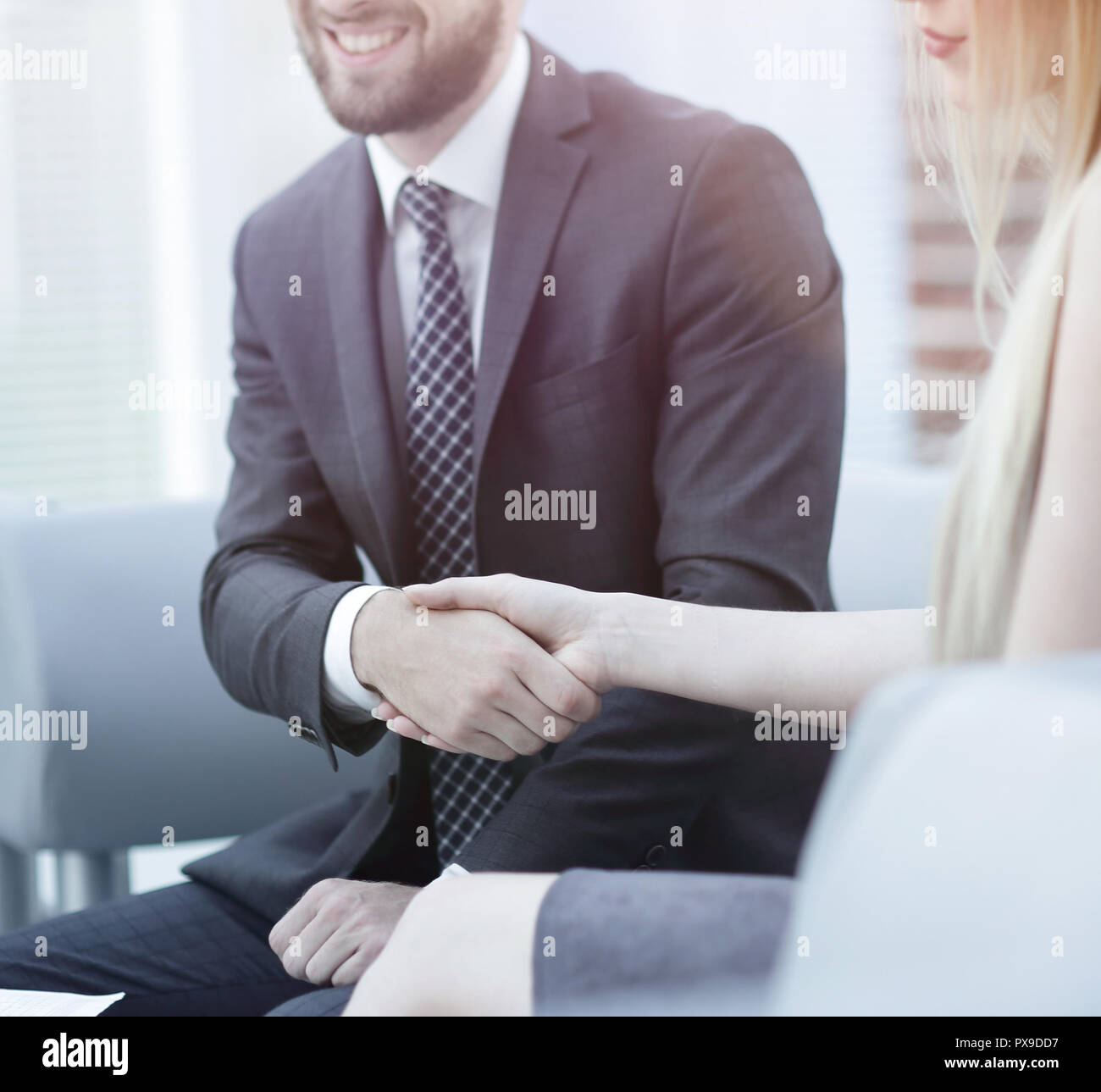 close-up of a manager shakes hands with a regular customer. the concept ...