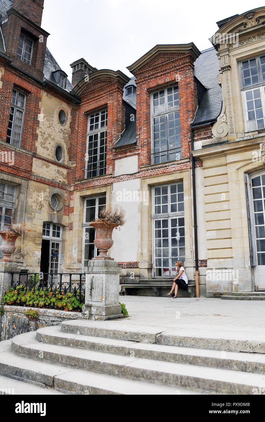 Wonderful facade at the Castel of Thoiry. Wittnesses of bygone times. The photographer is the woman sitting in the photo. Stock Photo