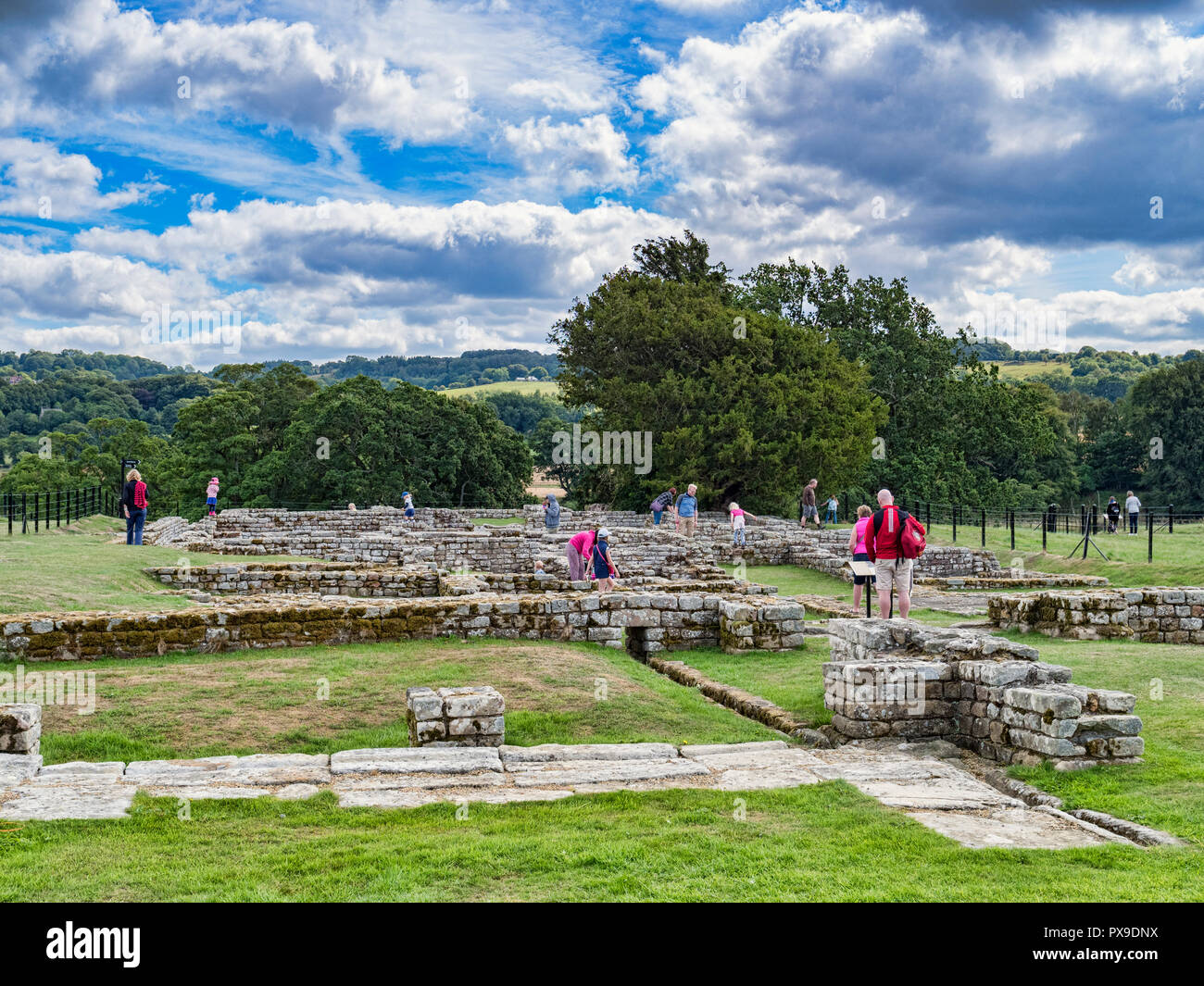 11 August 2018: Tourists viewing the excavated ruins of Chesters Roman Fort, Hadrian's Wall, Northumberland, UK Stock Photo
