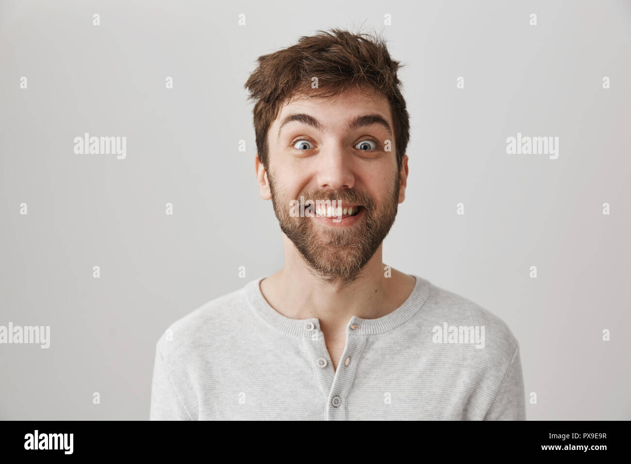 Funny And Crazy Bearded Guy With Messy Hair And Popped Eyes