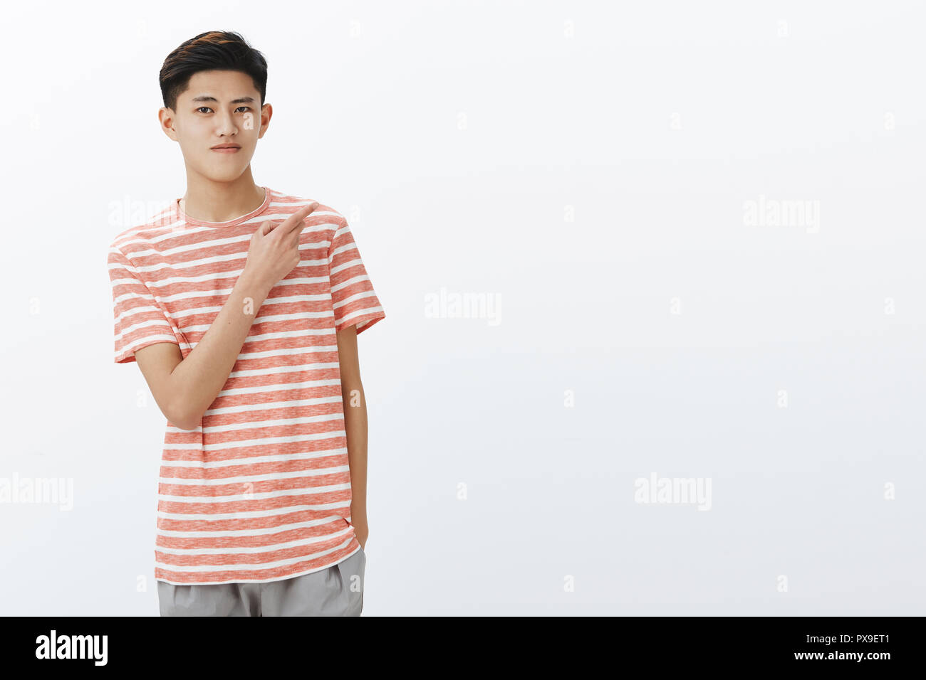 Portrait Of Calm Attractive Young Teenage Asian Guy With Dark