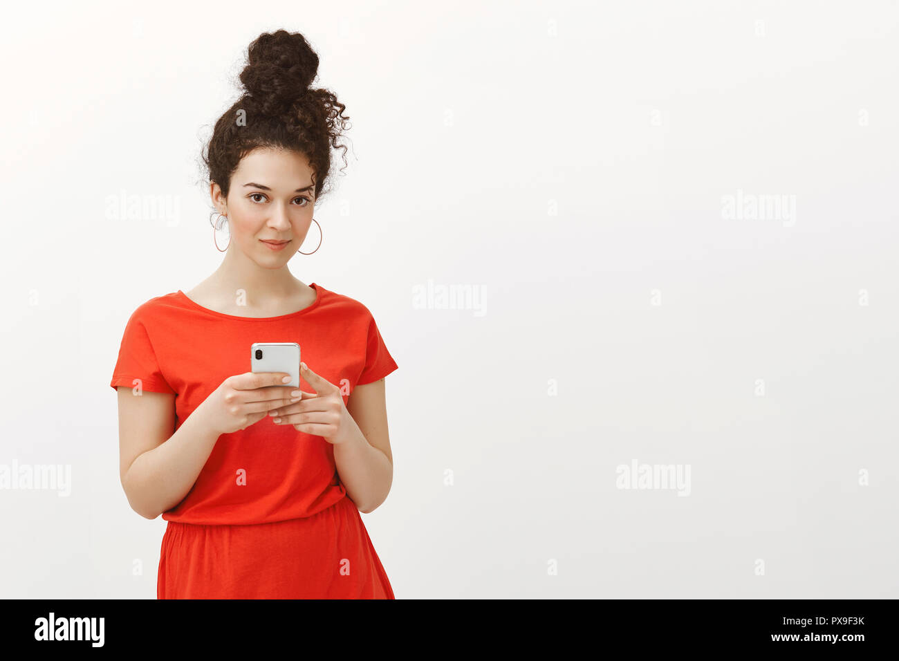 Good Looking Stylish Feminine Girl With Curly Hair Combed In Bun