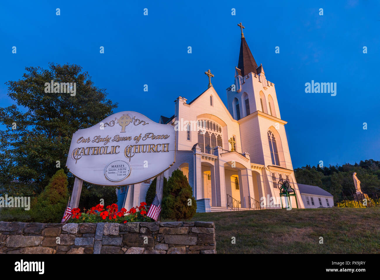 Our Lady Queen of Peace Catholic Church lit at night in Boothbay Harbor Maine Stock Photo